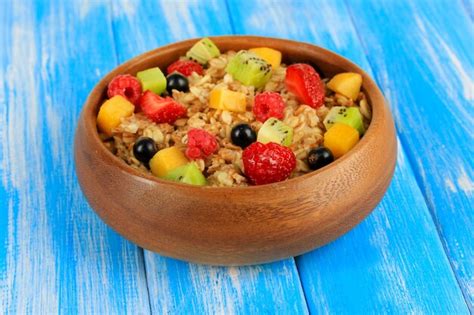 Premium Photo | Oatmeal with fruits on table closeup