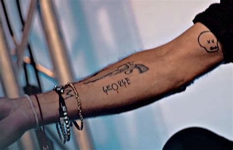 a man's arm with tattoos on it and the word love written in black ink