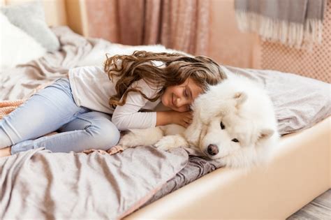 Premium Photo | Home portrait of cute child hugging with dog on the sofa