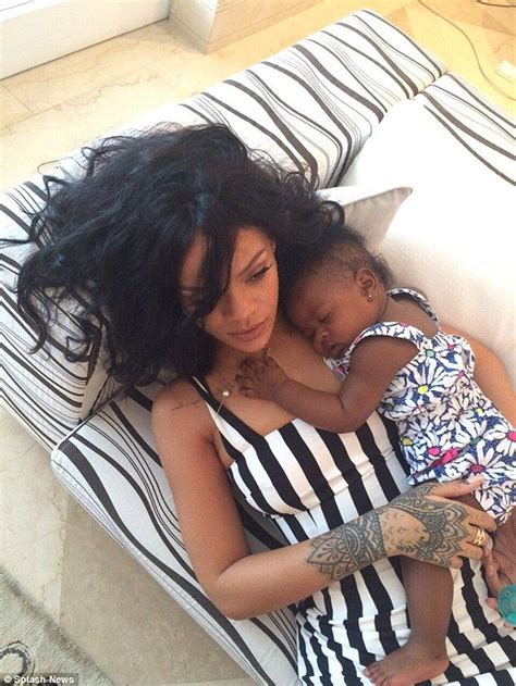 Family: Rihanna showed off a more maternal side as she snuggled with ...