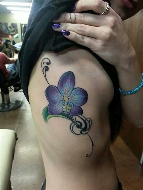 Beautiful blue purple orchid tattoo with filigree on the ribcage ...