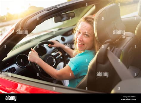 Caucasian woman driving convertible Stock Photo - Alamy