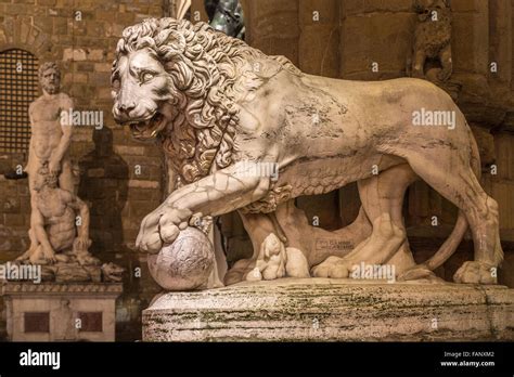 Sculpture of an ancient lion at night, marble statue in front of the ...