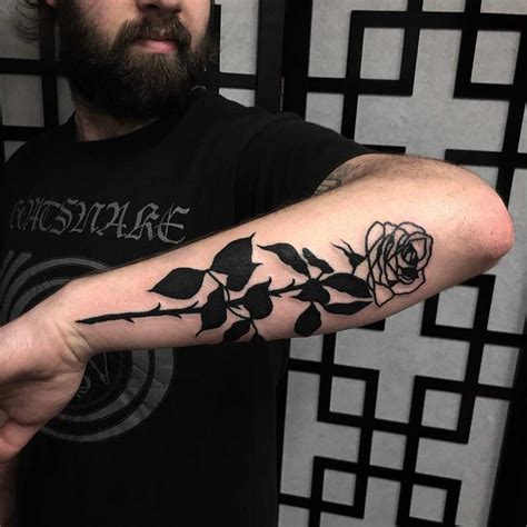 Black rose tattoo on the left forearm - Tattoogrid.net