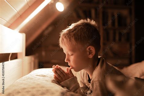 Little boy praying in bed before sleep Stock Photo | Adobe Stock