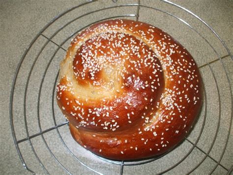 a close up of a bun on a rack with sesame seed sprinkles