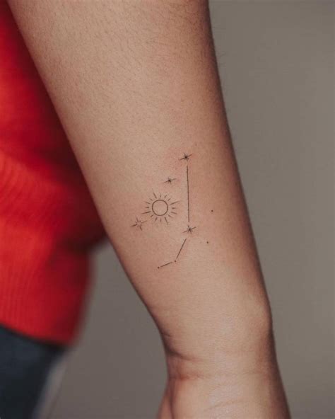 Fine line Aries constellation tattoo on the wrist.