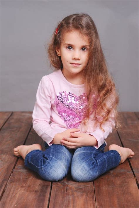 Cute Little Girl Sitting On Wooden Floor Stock Image - Image: 44910737