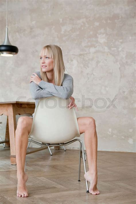 woman sitting on chair with naked legs | Stock image | Colourbox