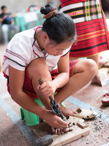 Ifugao Woman Doing A Wood Carving Using Small Knife In Banaue ...