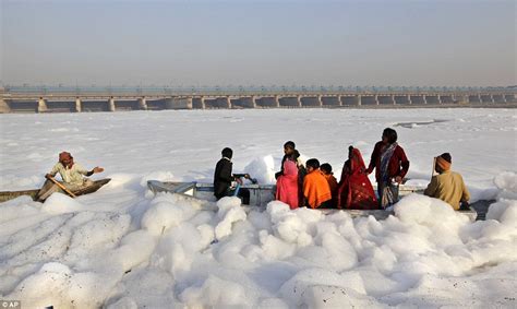 An industrial bubble bath: Hindus dive in foam-coated polluted Yamuna ...