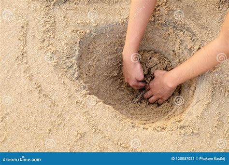 Girl Digging a Big Hole for Fun Playing at the Sea Beach. Stock Image ...