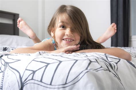 Portrait of Beautiful Little Girl Lying on Bed Stock Photo - Image of ...