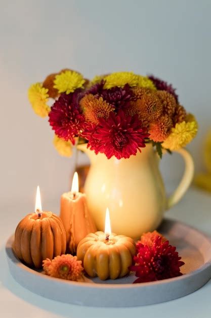 Premium Photo | Cozy autumn mood Flowers and candles