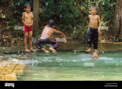 Thakhek, Laos - April 20, 2018: Local children jumping in the water and ...