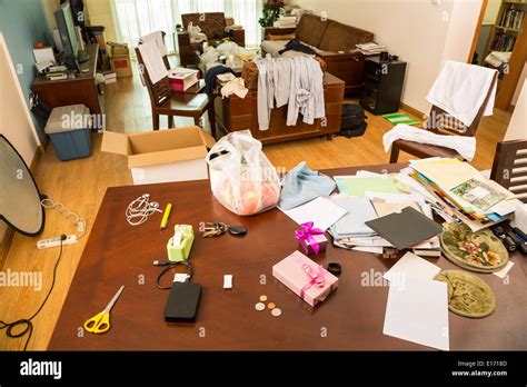 Messy living room with clothes and other stuff Stock Photo - Alamy