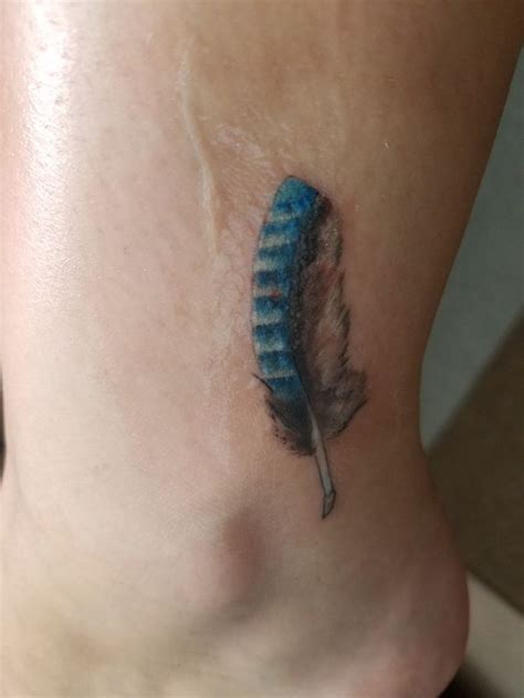 Small blue jay feather tattoo from Joe at Golden Needle in Moorhead, MN ...