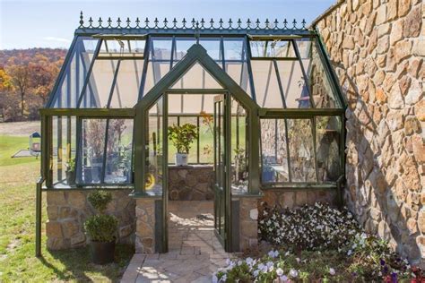 Greenhouse against stone wall. The wall will radiate the heat gathered ...