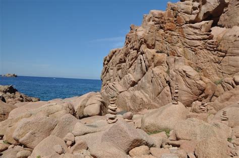 Premium Photo | Rock formation on beach against clear sky