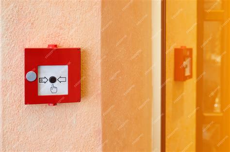 Premium Photo | Fire alarm system in red box installed on wall of building.