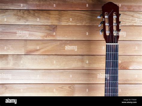 Guitar fretboard on wooden background Stock Photo - Alamy