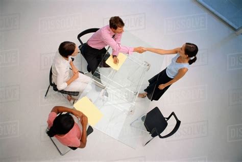 Business people shaking hands in meeting - Stock Photo - Dissolve