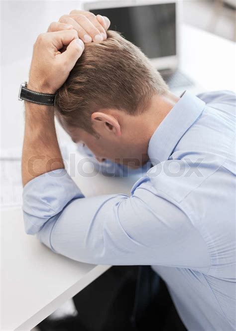 stressed businessman with papers at work | Stock image | Colourbox