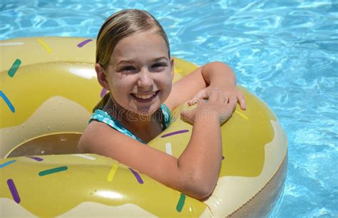 Smiling girl in pool float stock photo. Image of concept - 119809852