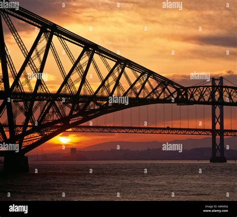 Forth Rail Bridge at sunset with road bridge beyond over Firth of Forth ...