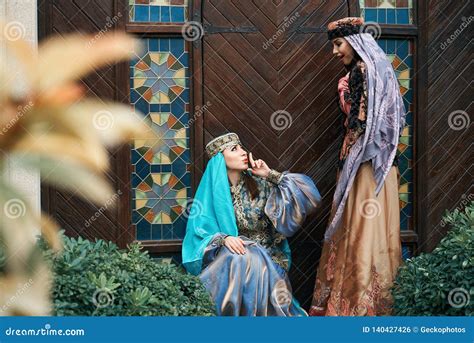 Women in Traditional Azerbaijani Dress Knocking the Wooden Door of an ...