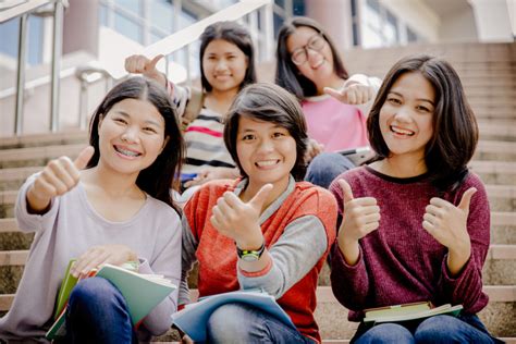 group of happy teen high school students outdoors - Savvy Tokyo