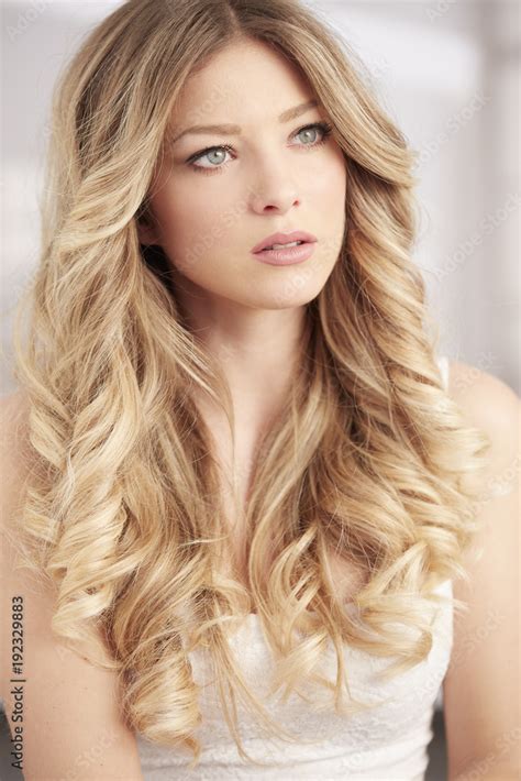 blonde girl with long curl hair and blue eyes portrait Stock Photo ...