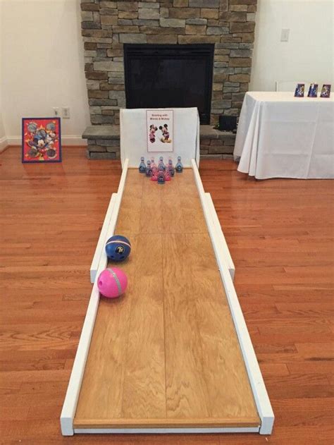 a bowling game is set up on the floor in front of a fire place and ...