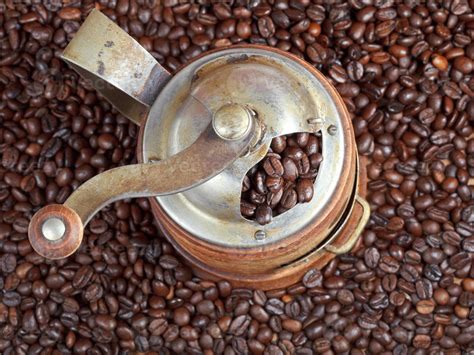 retro manual coffee mill on roasted beans 11691563 Stock Photo at Vecteezy