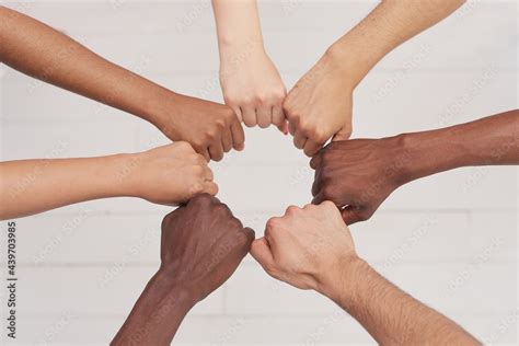 Multiethnic people holding hands in a circle together, multiethnic ...