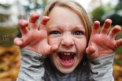 Child making a scary face stock photo - OFFSET