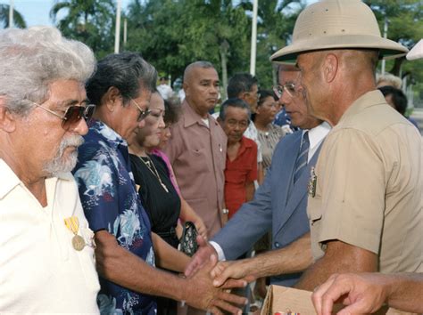 Governor Ricardo J. Bordallo of Guam shakes hands with one of the 34 ...