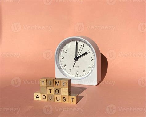 Time to adjust - adjusting or changing the time on white clock. Time ...