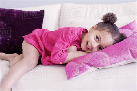 Little girl lying on couch - Stock Photo - Dissolve