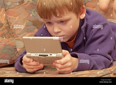 portrait of a young boy playing with his Nintendo Stock Photo - Alamy