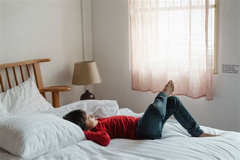 Photo of Boy Lying Down on Bed · Free Stock Photo