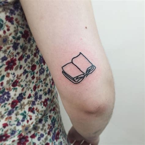 Open book tattoo by Suki Lune - Tattoogrid.net