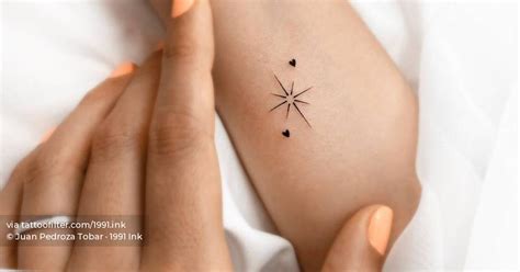 Minimalist North Star and hearts tattoo on the wrist.