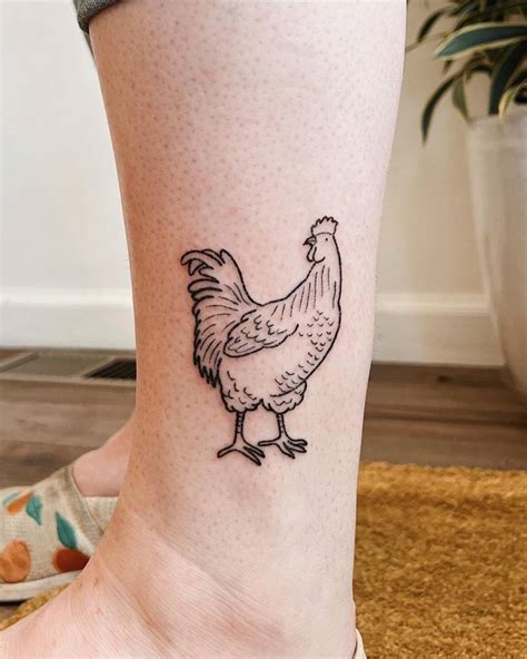 Hand poked chicken tattoo located on the ankle.