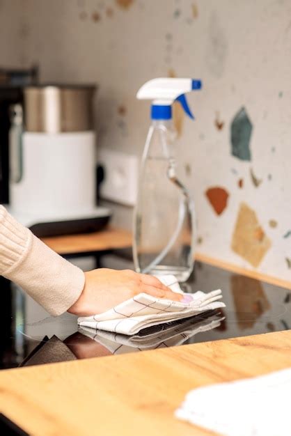 Premium Photo | Cleaning the induction hob with detergent and sponges