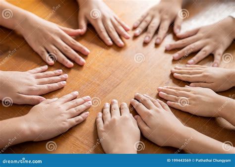 Multicultural Hands Man Woman Children in Circle on Brown Wooden ...