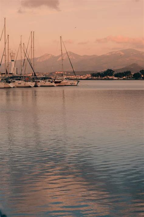 A boat is docked at a marina with mountains in the background · Free ...