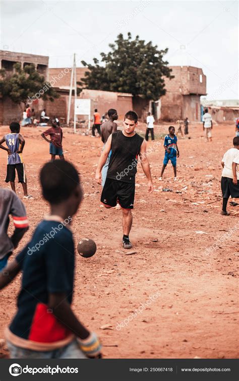 Black african children playing soccer with caucasian volunteer – Stock ...