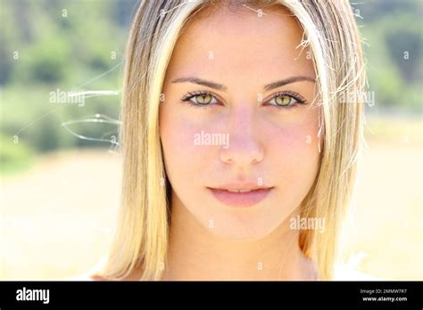 Front view portrait of a beautiful woman with green eyes looks at ...