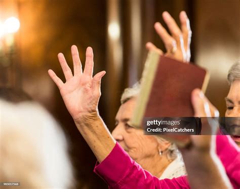 Close Up Of Congregation Raising Hands And Singing At Church High-Res ...